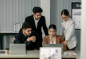 Financial advisors collaborate to assess a company's financial performance using data from its operational activities. Team members work together in a discussions meeting to develop a business plan. photo
