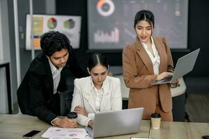 Financial advisors collaborate to assess a company's financial performance using data from its operational activities. Team members work together in a discussions meeting to develop a business plan. photo