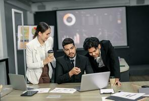Financial advisors collaborate to assess a company's financial performance using data from its operational activities. Team members work together in a discussions meeting to develop a business plan. photo