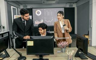 Financial advisors collaborate to assess a company's financial performance using data from its operational activities. Team members work together in a discussions meeting to develop a business plan. photo