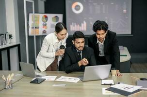 Financial advisors collaborate to assess a company's financial performance using data from its operational activities. Team members work together in a discussions meeting to develop a business plan. photo