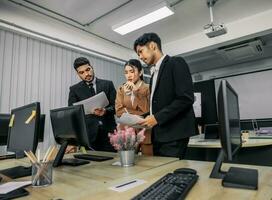 Financial advisors collaborate to assess a company's financial performance using data from its operational activities. Team members work together in a discussions meeting to develop a business plan. photo