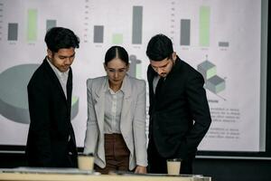 Financial advisors collaborate to assess a company's financial performance using data from its operational activities. Team members work together in a discussions meeting to develop a business plan. photo