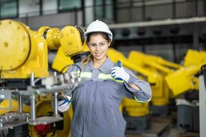Robotic technicians tighten and loosen components with screwdriver and plier to perform safety maintenance. Measuring current, voltage, resistance, capacity, temperature with digital clamp meter. photo
