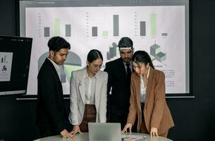 Financial advisors collaborate to assess a company's financial performance using data from its operational activities. Team members work together in a discussions meeting to develop a business plan. photo