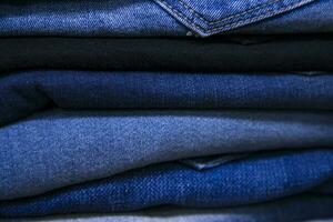 folded blue jeans pant pattern texture can be used as a background wallpaper photo