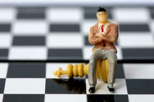 Businessman model on chess board. photo