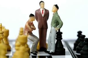 Businessman model on chess board. photo