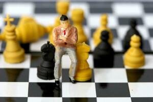 Businessman model on chess board. photo