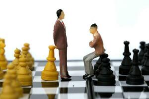 Businessman model on chess board. photo