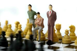 Businessman model on chess board. photo