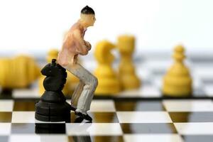 Businessman model on chess board. photo