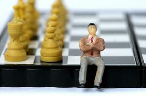 Businessman model on chess board. photo