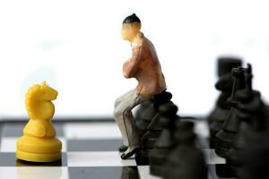 Businessman model on chess board. photo