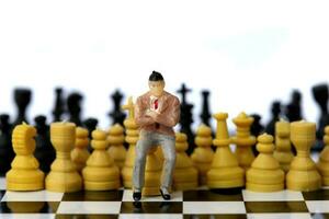 Businessman model on chess board. photo