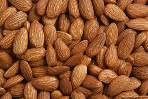 Pattern Organic almond nut raw peeled as background, top view. Healthy snack or for vegetarians. copy space banner. photo