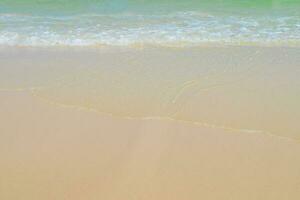 hermosa arenoso playa y suave azul Oceano ola. verano antecedentes concepto foto
