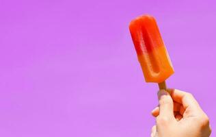 Ice cream in hand with copy space for text. summer background concept photo