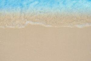 beautiful sandy beach and soft blue ocean wave. summer background concept photo