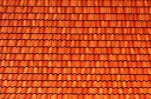 Orange Roof tiles have a seamless texture and roof pattern. The concept for the roof housetop icon with brown roofing tiles. banner texture for roofers. photo