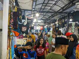 Blitar, indonesia - april, 2023 - the view of an alley where many vendors sell local handicrafts and clothes to visitors photo