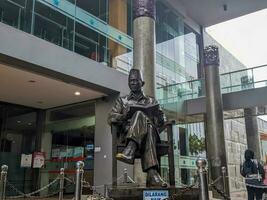 Blitar, indonesia - april, 2023 - Bung Karno statue sitting holding a book in the Bung Karno library photo