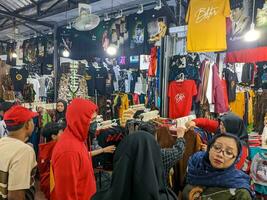 Blitar, indonesia - april, 2023 - the view of an alley where many vendors sell local handicrafts and clothes to visitors photo