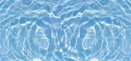 Blue water with ripples on the surface. Defocus blurred transparent blue colored clear calm water surface texture with splashes and bubbles. Water waves with shining pattern texture background. photo