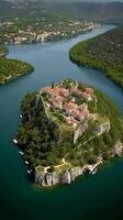 an aerial view of Skradin's historic center, with its winding streets and colorful buildings nestled among the lush greenery. photo