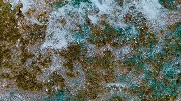 The texture of a stream of water flowing with great pressure and forming white foam. Abstract background. video