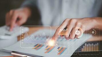 A man read and calculate business statistical chart reports to analyze and improve corporate strategy ,Manage financial and marketing documents, Company growth information ,Managing Business Insights photo