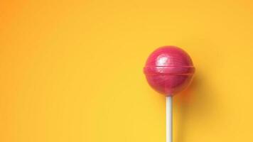 Sweet lollipop on bright yellow background with copy space photo