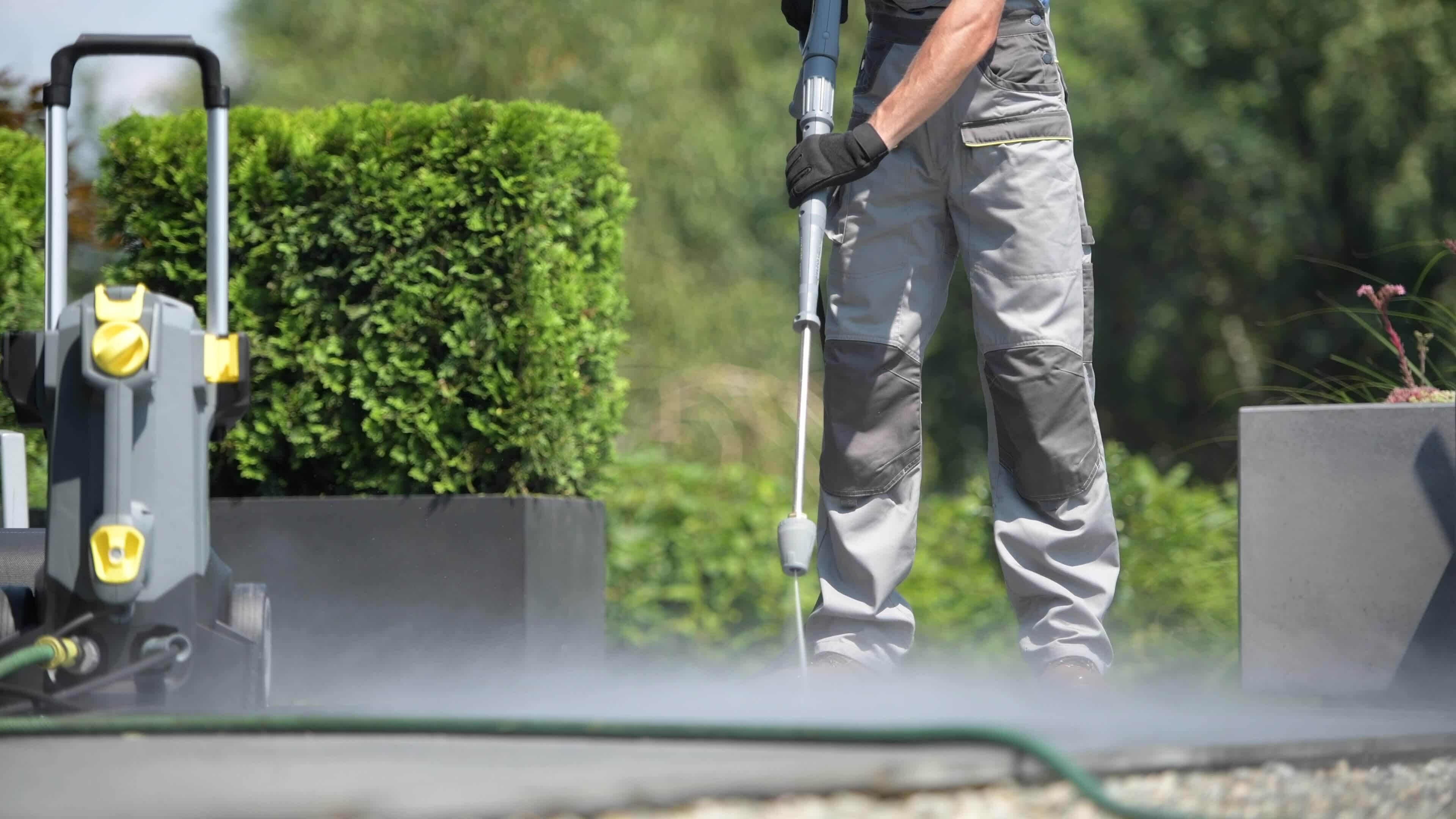 Caucasian Worker Cleaning Patio Using Pressure Washer 24163060 Stock