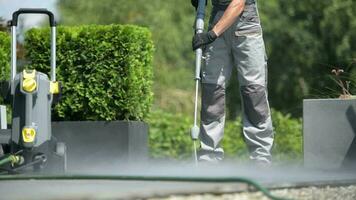 Caucasian Worker Cleaning Patio Using Pressure Washer video