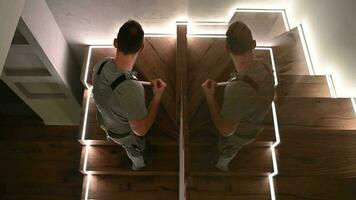 Men in His 30s Mopping Wooden Stairs Inside His Apartment. video