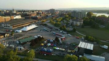 Festival grounds in La Crosse, Wisconsin. Beverage and food area with tents.  Hotel and parking lot seen. Sidewalks surrounding festival grounds. video