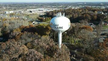 Aerial view of Eau Claire, Wisconsin, water tower and new residential neighborhood below. Park in autumn with brilliant colors. video