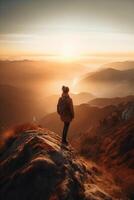 a man is standing on a mountain. photo