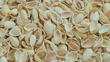 looped rotating empty pistachios shells full frame close-up background video