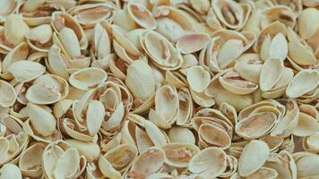 looped rotating empty pistachios shells full frame close-up background video