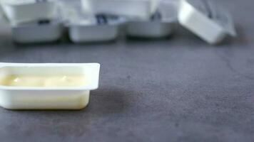 Close up of fresh butter in a small plastic container video