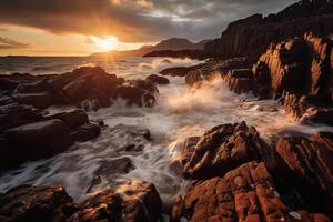 The waves are crashing over the rocks at sunset. photo