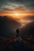 a man is standing on a mountain. photo