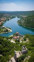 an aerial view of Skradin's historic center, with its winding streets and colorful buildings nestled among the lush greenery. photo