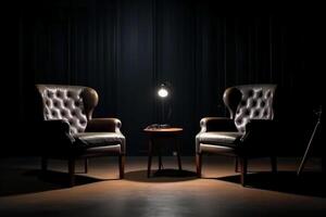 Two chairs and spotlights in podcast or interview room on dark background. photo