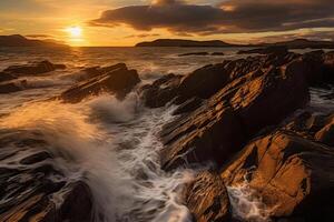 The waves are crashing over the rocks at sunset. photo