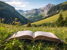 Book on the meadow with mountain at background. photo