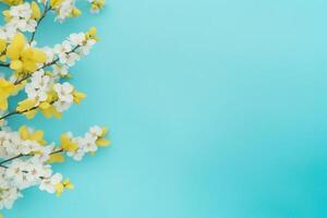 Spring flowers on blue yellow pastel background top view in flat lay style. photo