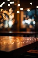 Image of wooden table in front of abstract blurred background of restaurant lights. photo