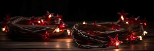 Christmas background with blue light luminous garlands and red stars on a white wooden background with copy space. photo